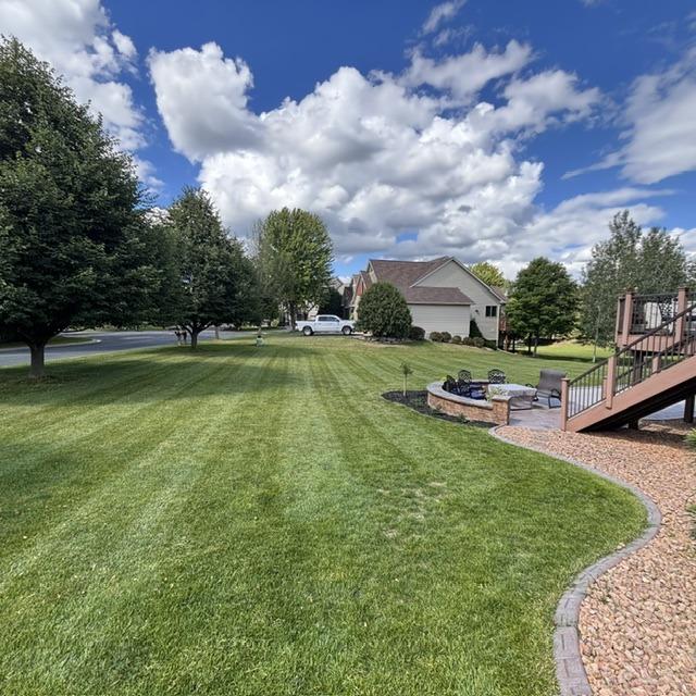 Striped Lawn With Paver Firepit, landscaping in Waconia, MN
